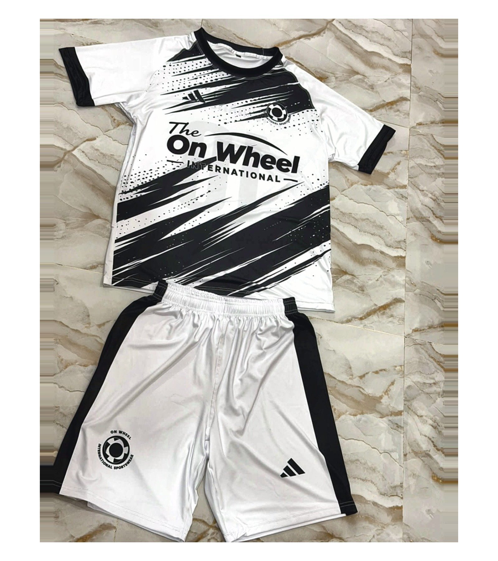 Complete custom football kit — jersey and shorts — made by On Wheel International in Sialkot